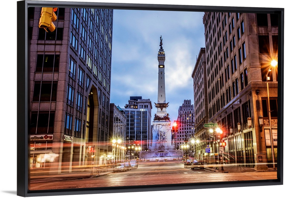 The Soldiers and Sailors Monument in the evening with lights from passing traffic in Indianapolis, Indiana.