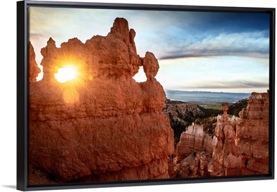 Sun peeking through a natural hole in the hoodoos at Bryce Canyon National Park, Utah