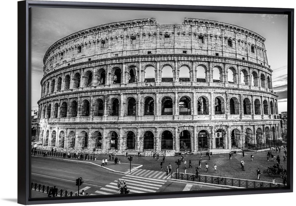 Photograph of the Colosseum lit up at dusk.