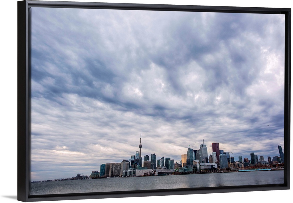Toronto city skyline under dramatic clouds, Ontario, Canada.