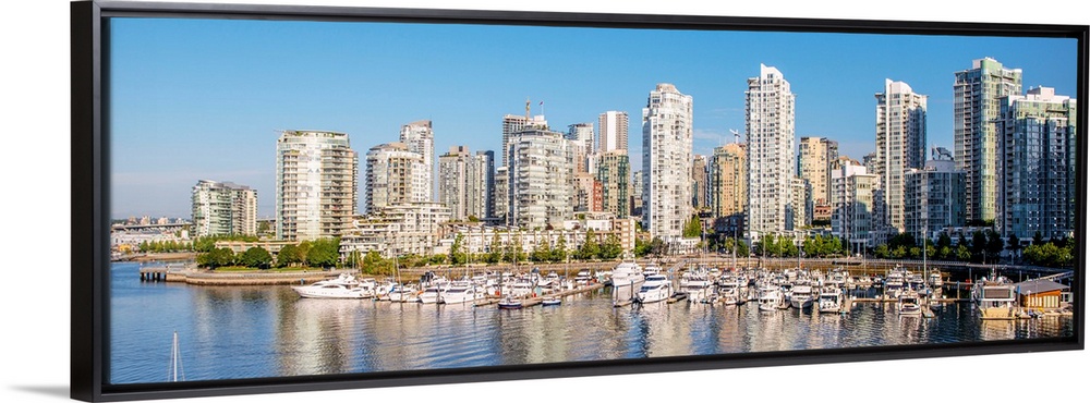 Panoramic photograph of part of the Vancouver, British Columbia skyline with False Creek Harbor and boats in the foreground.