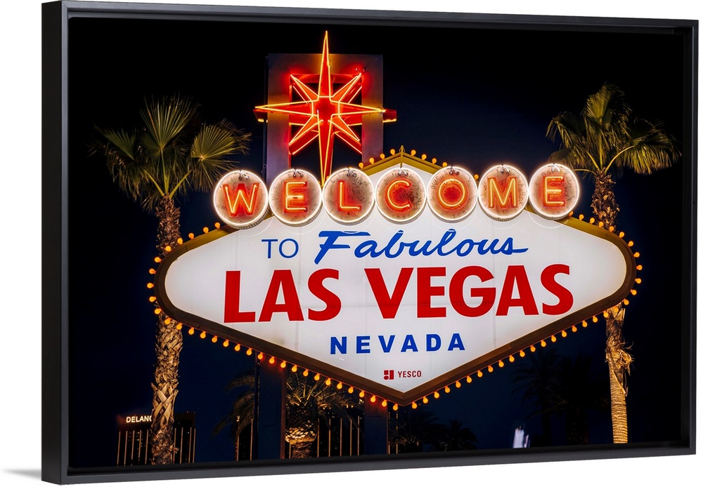 The famous "Welcome to Las Vegas, Nevada" sign is lit at night.