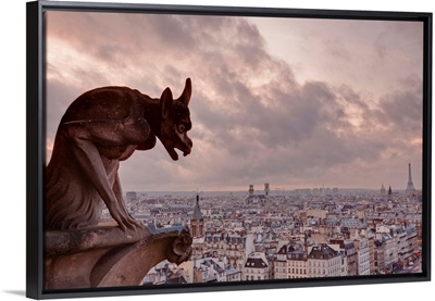 A gargoyle on Notre Dame de Paris cathedral looks over the city, Paris, France