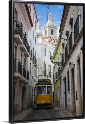 Famous tram 28 going through the old quarter of Alfama, Lisbon, Portugal