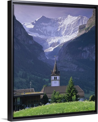Village church and Oberer Grindelwald Glacier, Swiss Alps, Switzerland