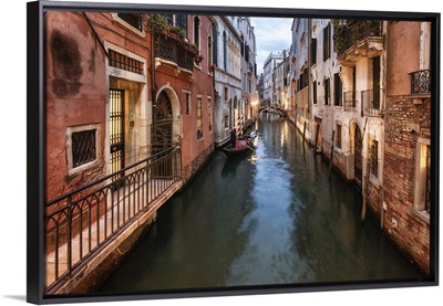 Gondola rowing in the canals of venice
