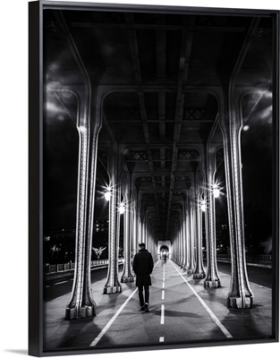 Man walking under overpass in Paris, France