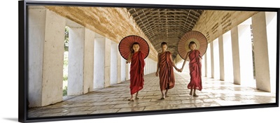 Monks with parasols in Mandalay, Burma