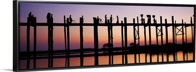 People walking across the UBein bridge at sunset in Mandalay