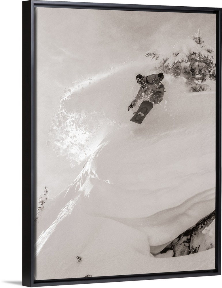 Black and white image of Pat Abramson kicking up powder while snowboarding down Mt. Baker in Washington.