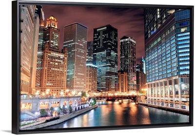 Chicago River Walk with skyscrapers illuminated at night
