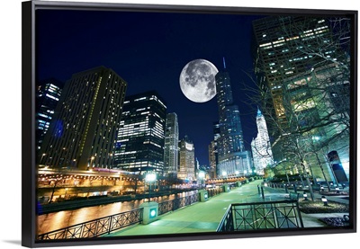 Dramatic view of Chicago at night, with large moon in the sky