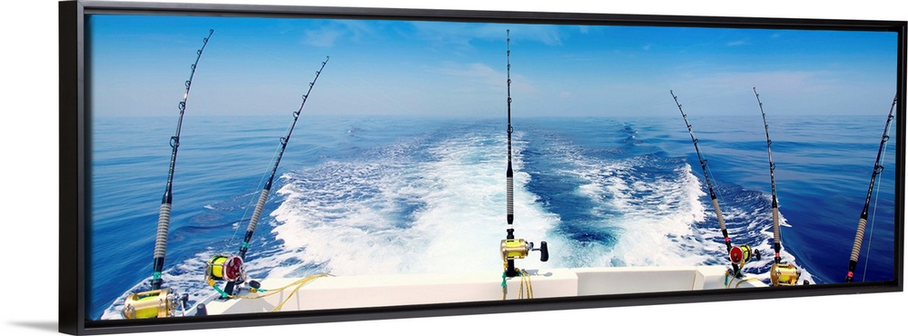 Fishing reels with cast lines off the back of a boat.