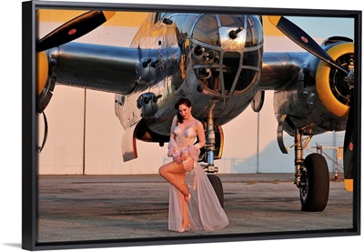 1940's pin-up girl in lingerie posing with a B-25 bomber