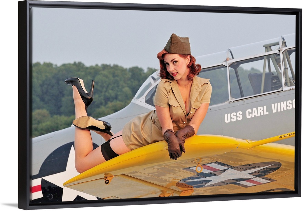 1940's style pin-up girl lying on a T-6 Texan training aircraft.