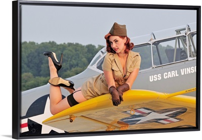 1940's style pin-up girl lying on a T-6 Texan training aircraft