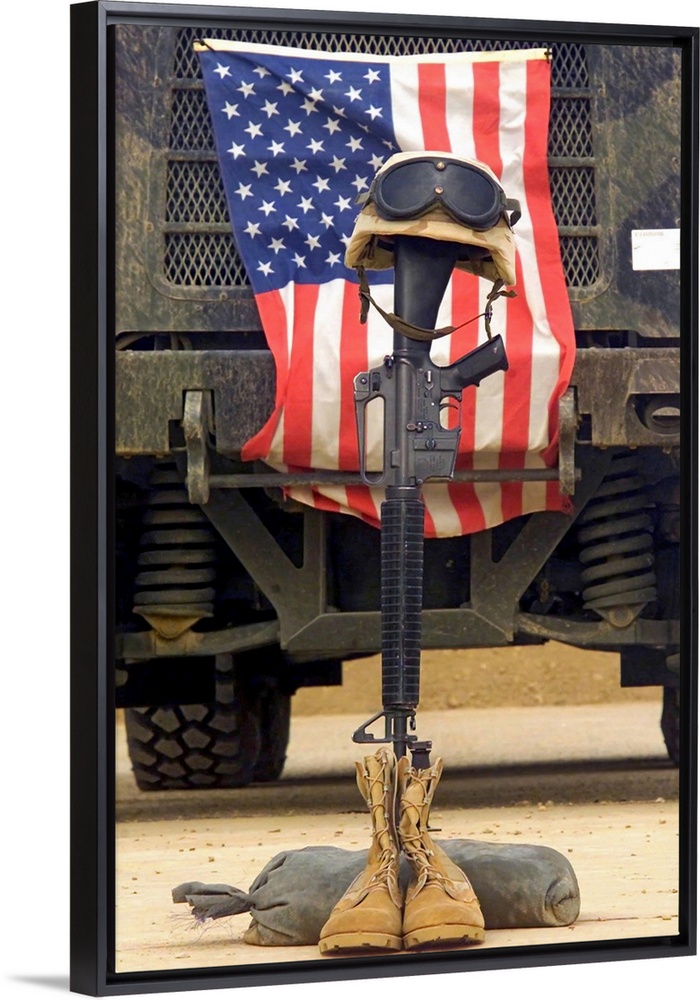Tall photo on canvas of a rifle sticking out of two boots with a helmet on top in front of an American flag.