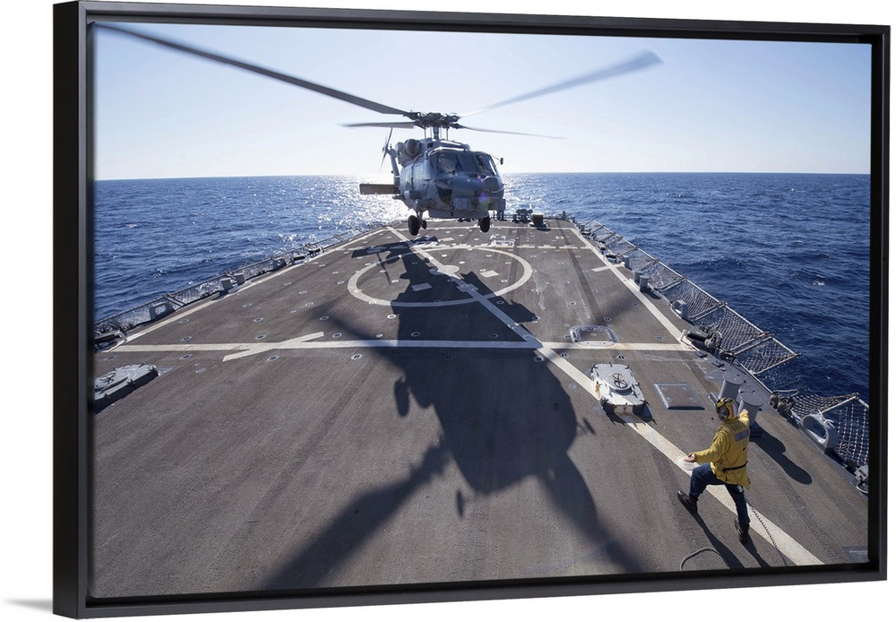 Mediterranean Sea, October 24, 2013 - Cryptologic Technician directs an SH-60R Sea Hawk helicopter to take off from the fl...