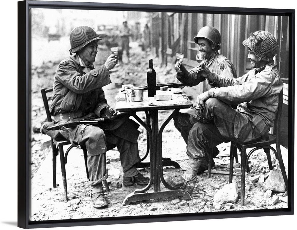 Three American soldiers at a sidewalk cafe in Paris, France, following the Allied liberation of the city, August 1944.