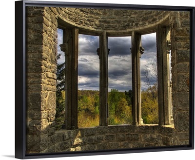 A bay window set in stoone walls overlooking the countryside