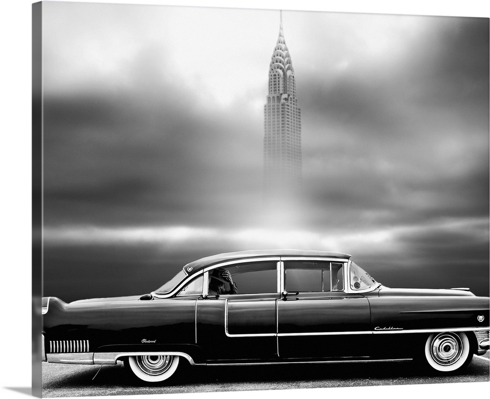 Square black and white photograph of a parked vintage Chrysler with a man in the backseat and the Empire State Building in...