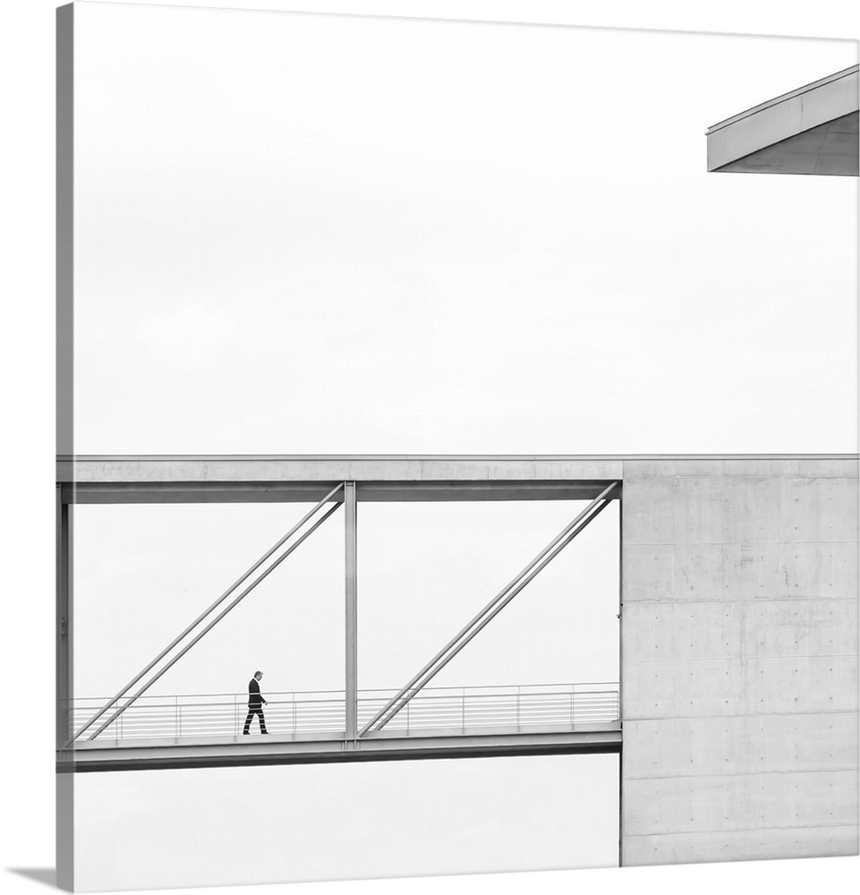 A figure walking across a skyway in a building with a simple profile.