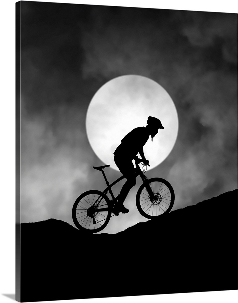 Silhouette of a biker pedaling up a hill, with the moon low in the sky.