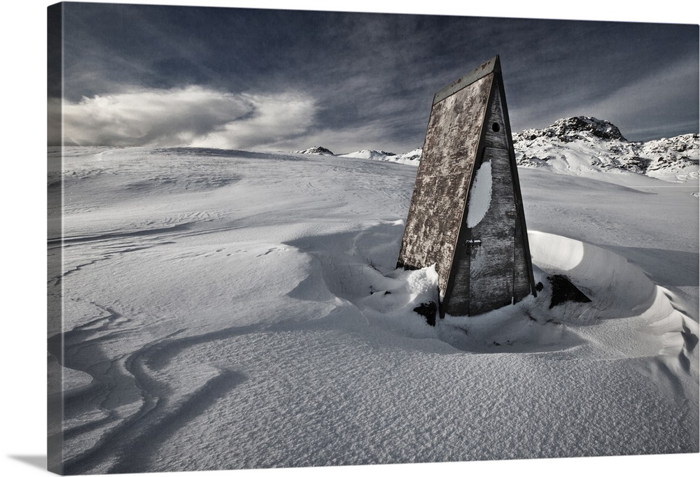 A triangular shack in the deep snow on the Reykjanes Peninsula, Iceland.