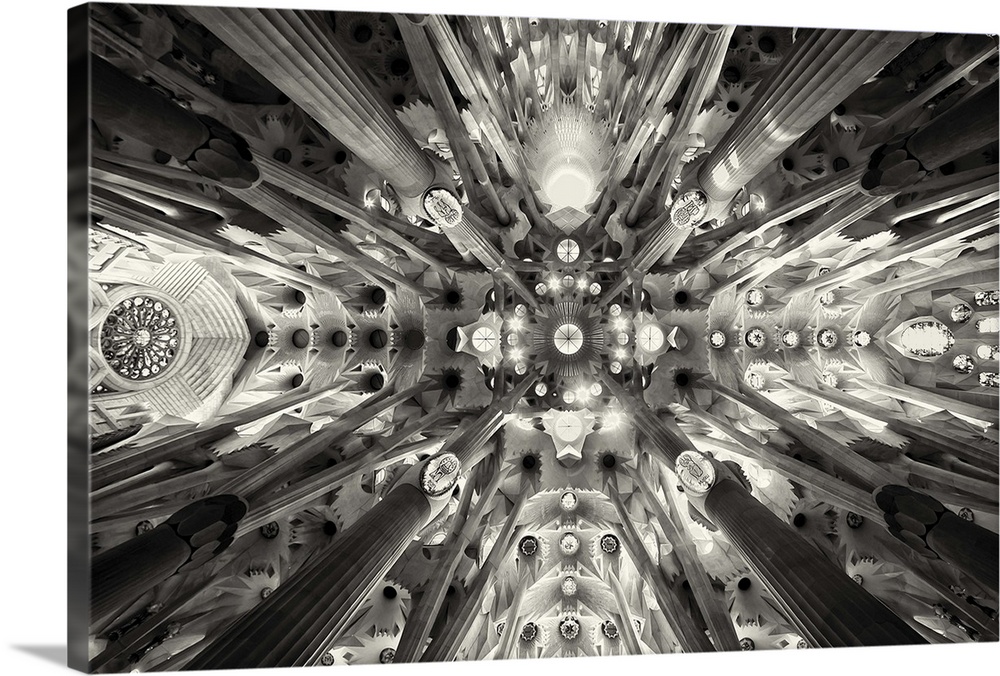 The intricate ceiling of La Sagrada Familia in Spain, resembling a forest of pillars and arches.