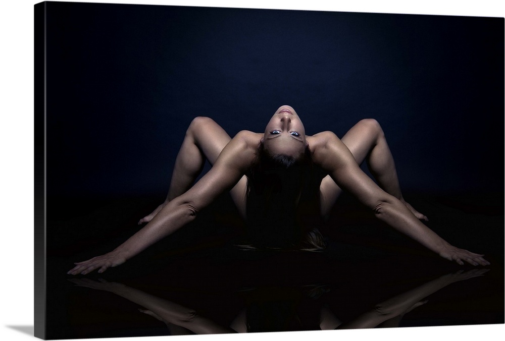 Nude portrait of a woman bending over backwards.