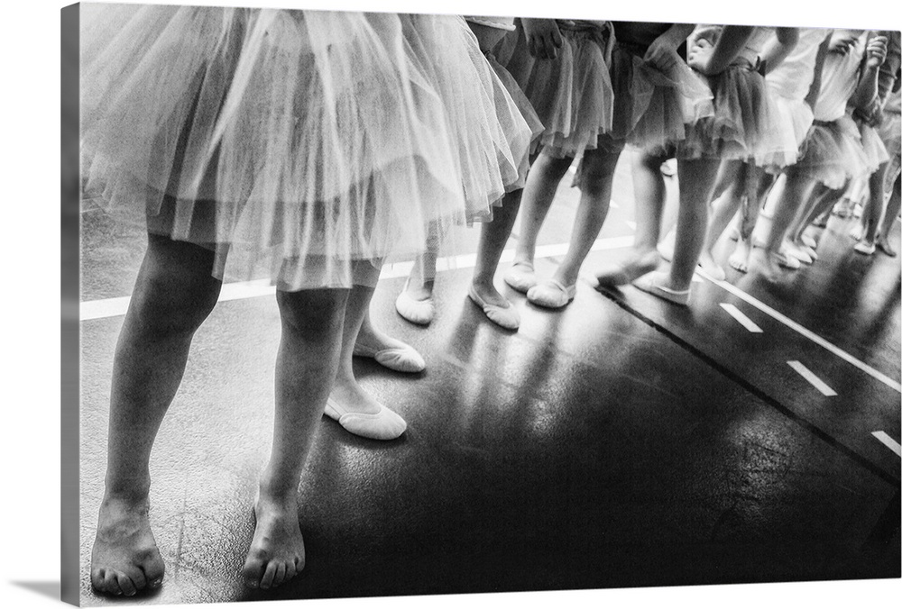 Black and white image of a group of young girls lined up for ballet class.
