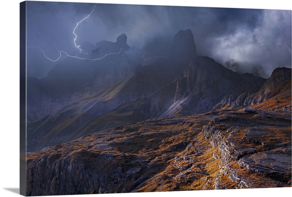 Fog shrouded mountainous landscape surrounded by striking lightning.