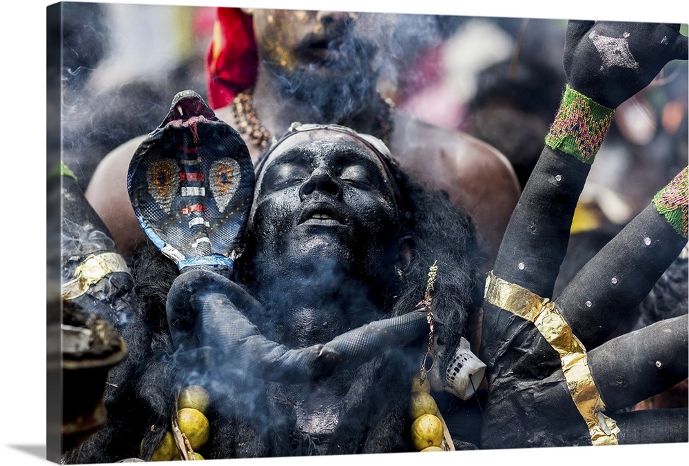 A man dressed like the Hindu god Kaali during a ritual celebration.
