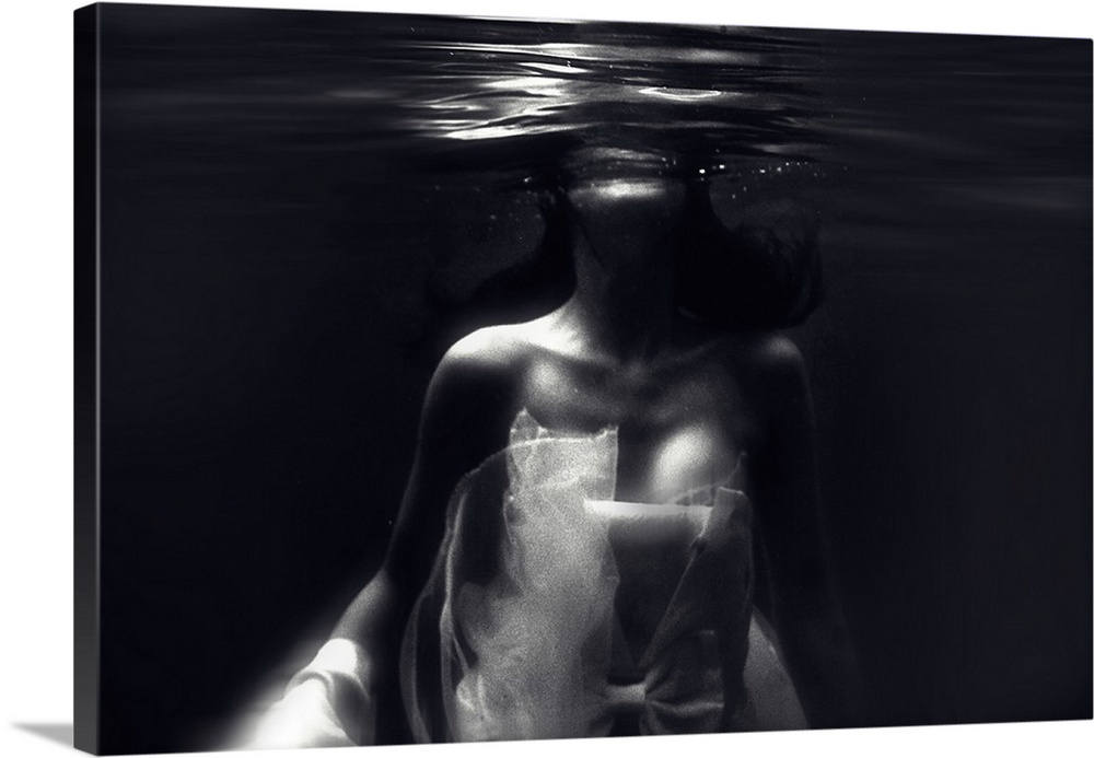Blurred image of a woman in a dress underwater near the surface.