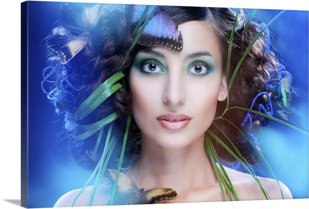 Artistic portrait of a beautiful woman with green reeds and blue butterflies around her face.