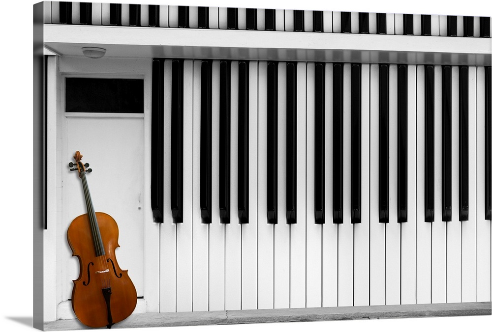 A cello resting against a house made of piano keys.