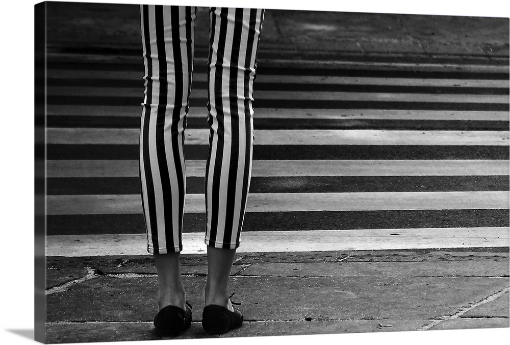 Black and white striped leggings perpendicular to the striped zebra crossing in the street.