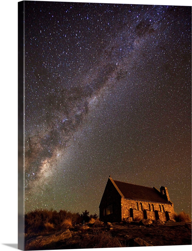 An old church near Lake Tekapo in New Zealand, under a starry night sky.