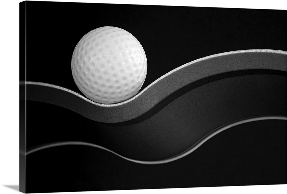 A golf ball nestled on a curve.