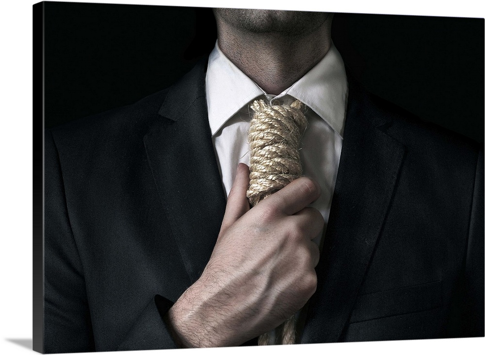 Conceptual image of a man tightening a noose instead of a tie around his neck.