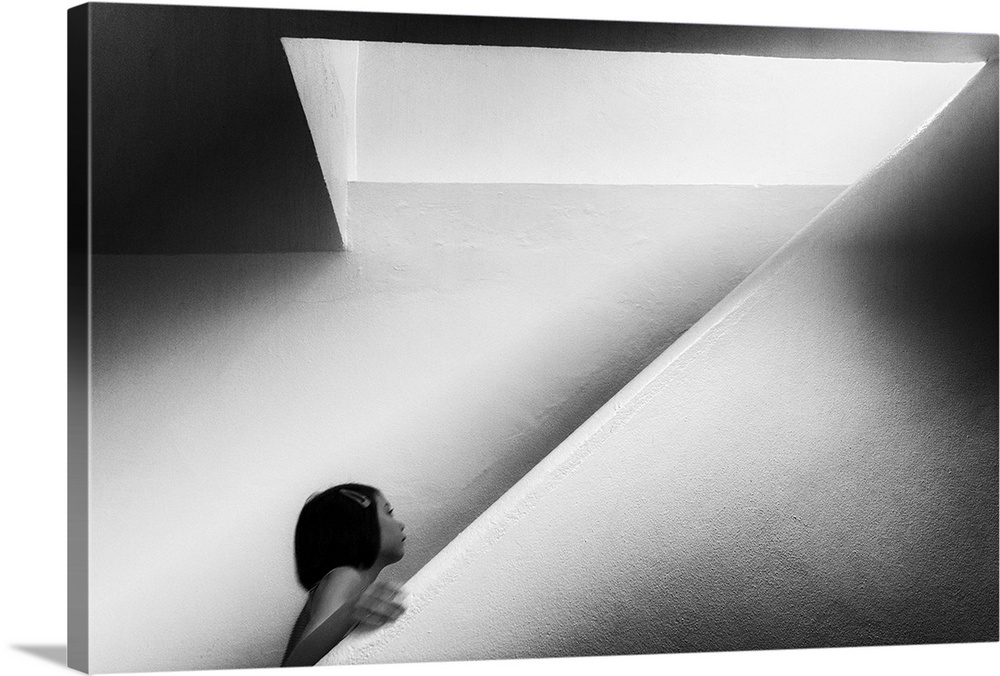 A girl walking up a flight of stairs the shape of the letter Z.