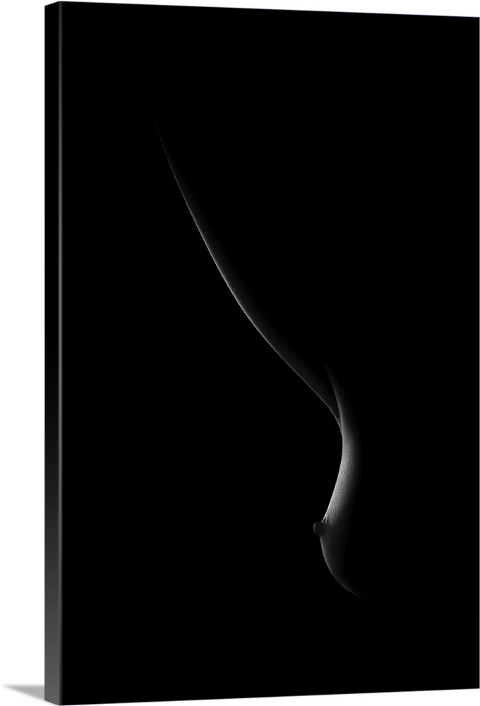 Black and white image of light on a woman's breast creating soft curving lines.