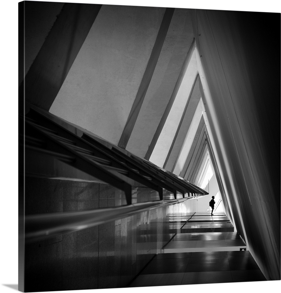 A triangular-shaped hallway in shadows with sharp corners creates an abstract image.