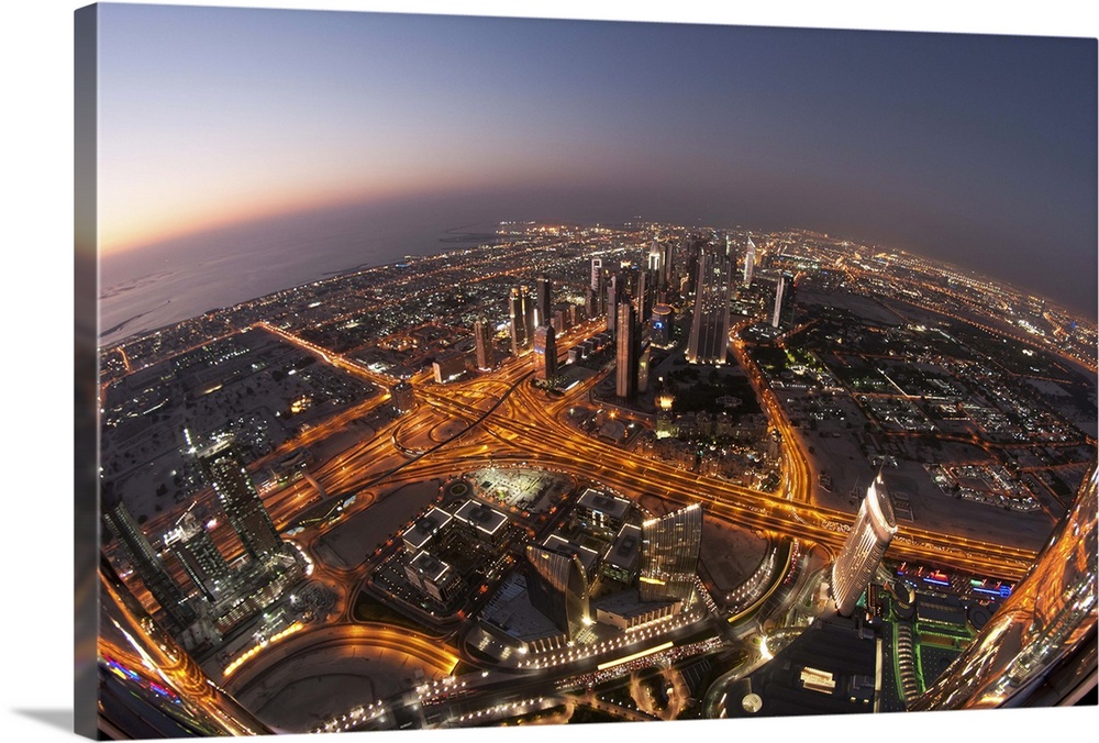 The busy city streets and skyscrapers of Dubai in the evening.