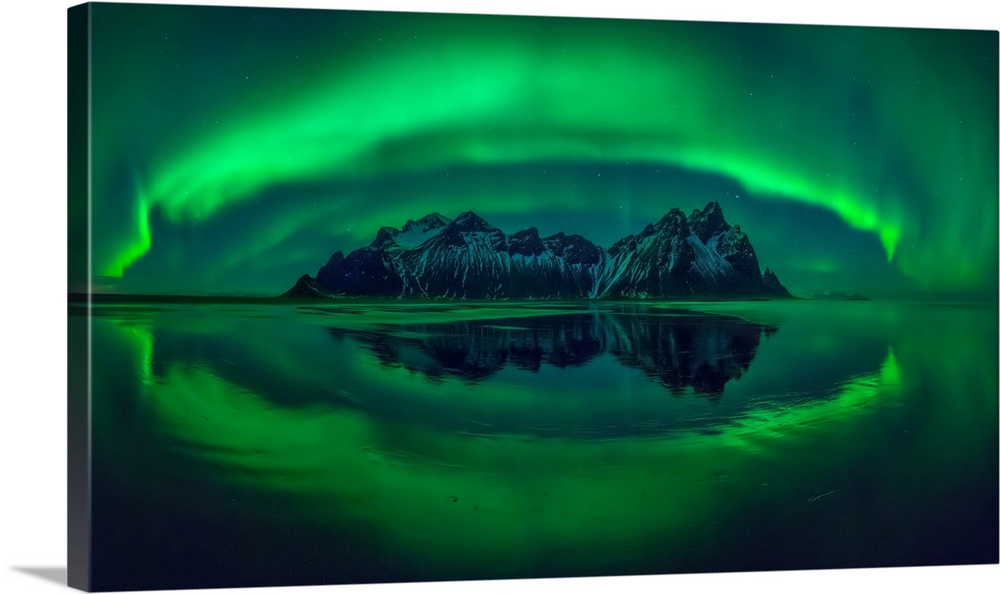 Aurora reflections on Stokksnes black beach with Vestrahorn mountains in center, Iceland.
