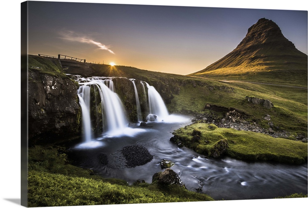 Waterfall and river near Kirkjufell mountain, Iceland, at sunset.