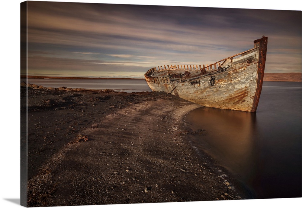 Decaying hull of an abandoned boat on the beach in Iceland.