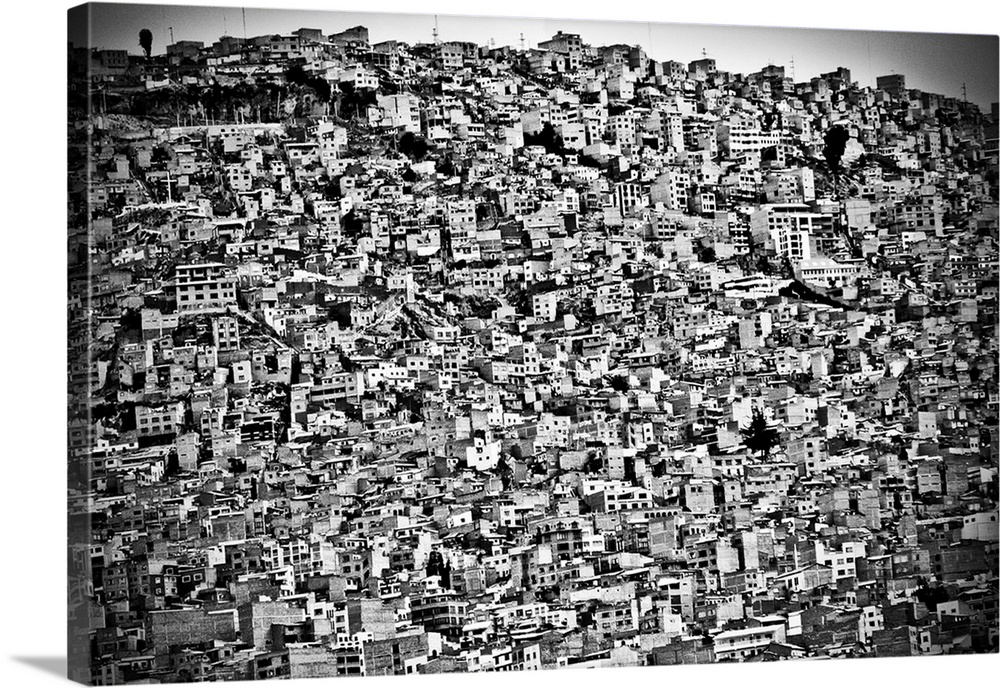 A black and white photograph of the cluttered mass of houses stacked on top of one another in Bolivia.