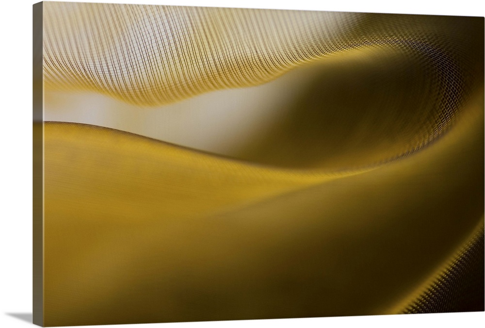 Abstract image of the folds and fibers of golden fabric.