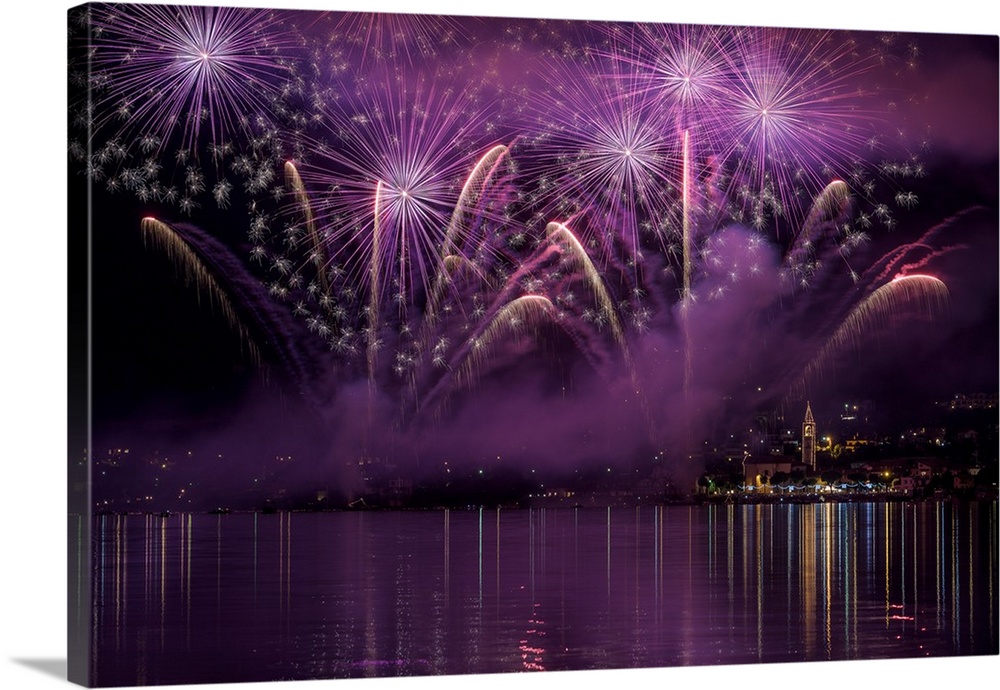 Purple fireworks fill the sky over Como, Italy.